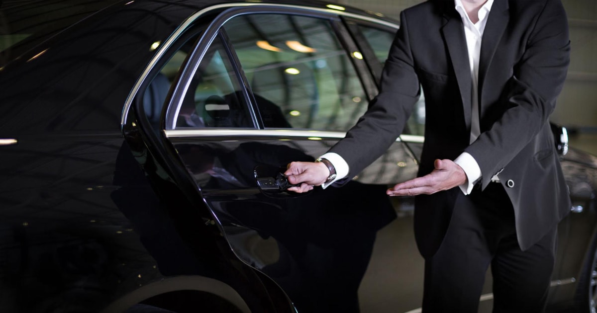 Chauffeur opening a car door for a passenger